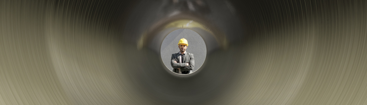 Man looks through pipe